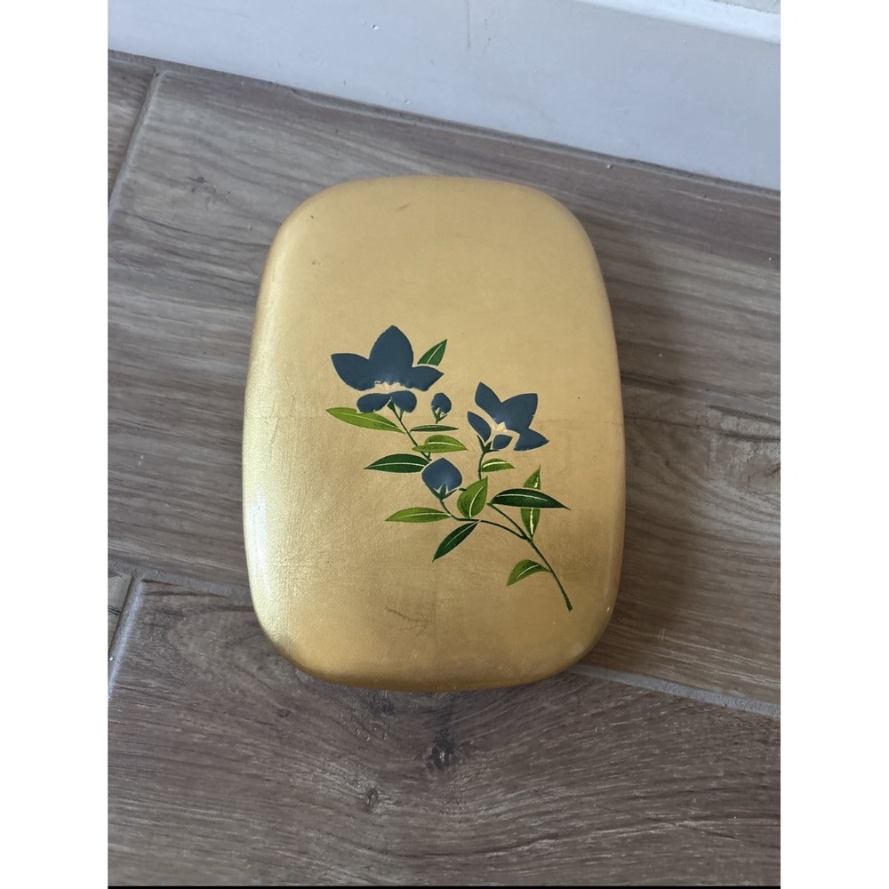 Oval-shaped accessory case with a flower pattern on a gold background 6"